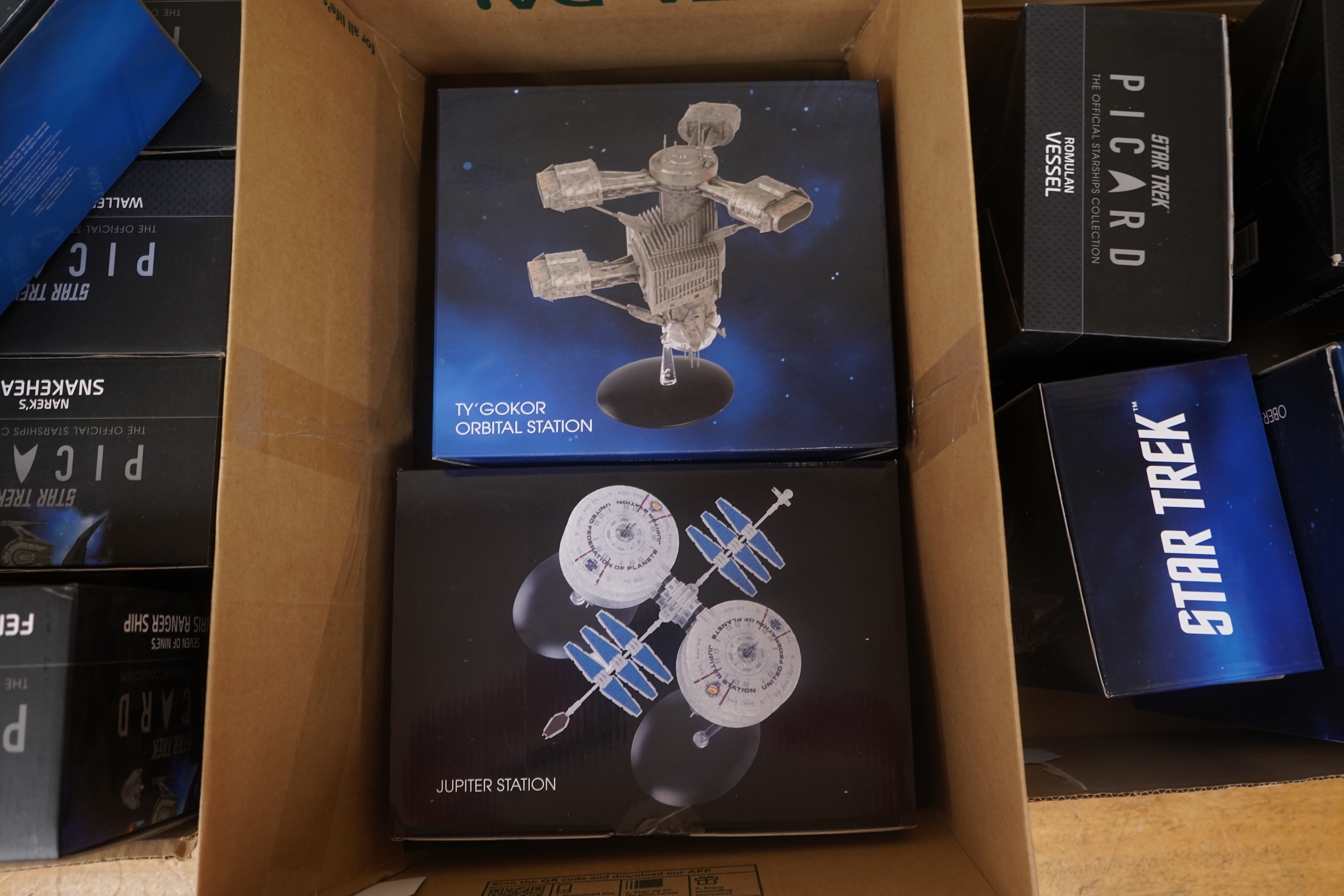Eighteen boxed Eaglemoss Star Trek magazine issue models, including; a Vulcan Cruiser, a Klingon Qugh Class vessel, a Son’a Battleship, a Romulan Flagship, Jupiter Station, Ty’Gokor Orbital Station, etc. Condition - good
